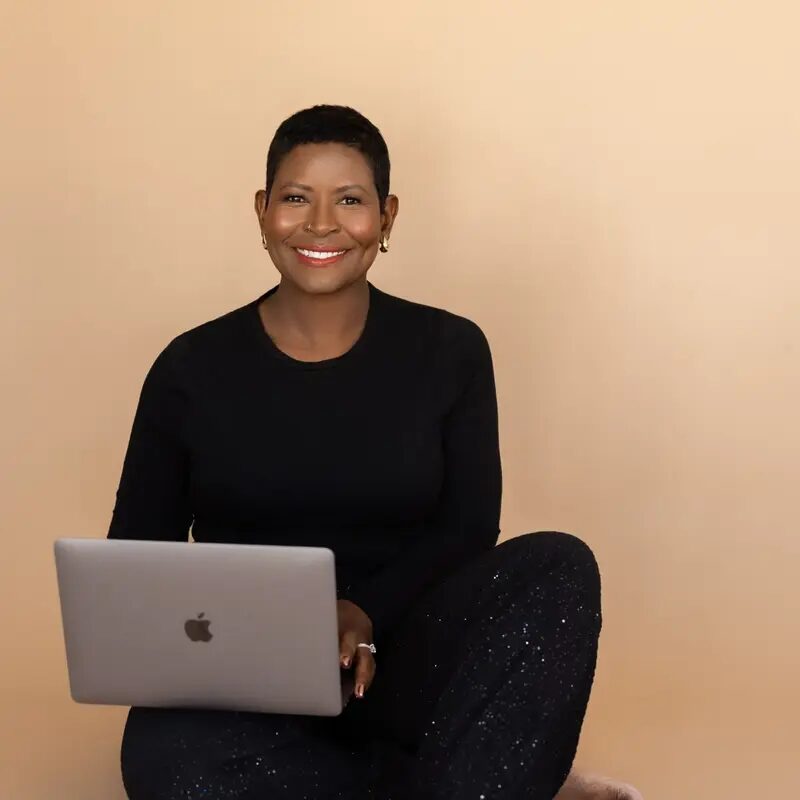 Sarah Kamoto seated with her laptop